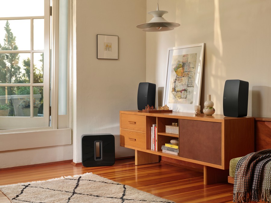 Credenza with two Sonos Play Five speakers on top and a Sonos Sub sitting on the floor.