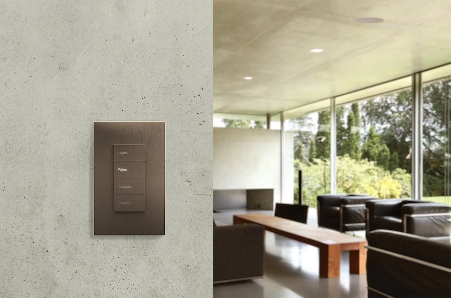 Lutron keypad overlooking a living room seating area. The buttons read Lights, Relax, Daylight, Shades.