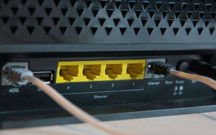 rear view of a router’s ethernet connection ports and wires